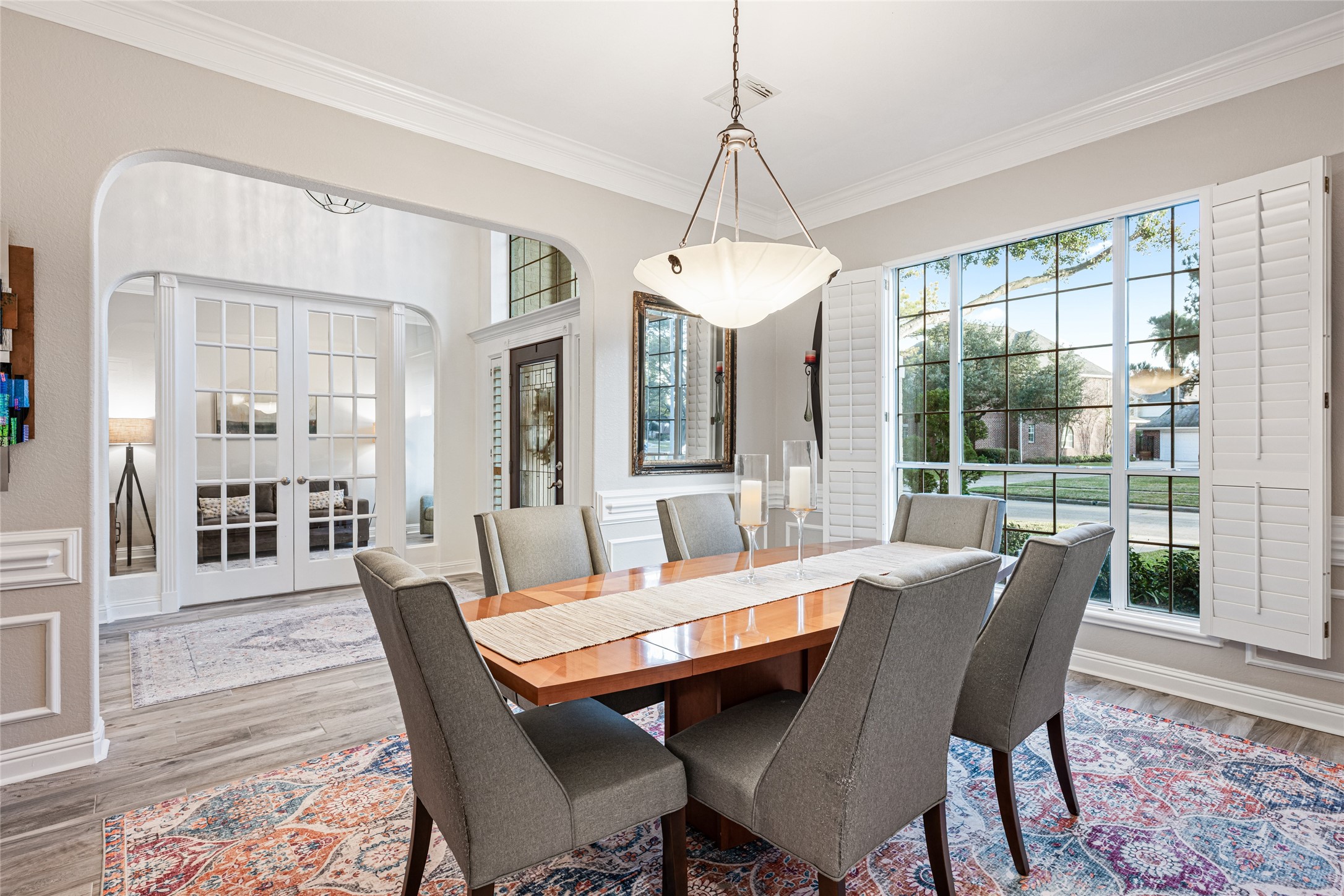 22806 2 Rivers Lane Katy, TX 77450 - Photo 18 of 49 The formal dining room is highlighted by a graceful arched entryway that adds architectural interest and elegant flow between spaces. Crown molding, plantation shutters and modern designer lighting complete the refined yet inviting setting, perfect for everyday dining or special gatherings.