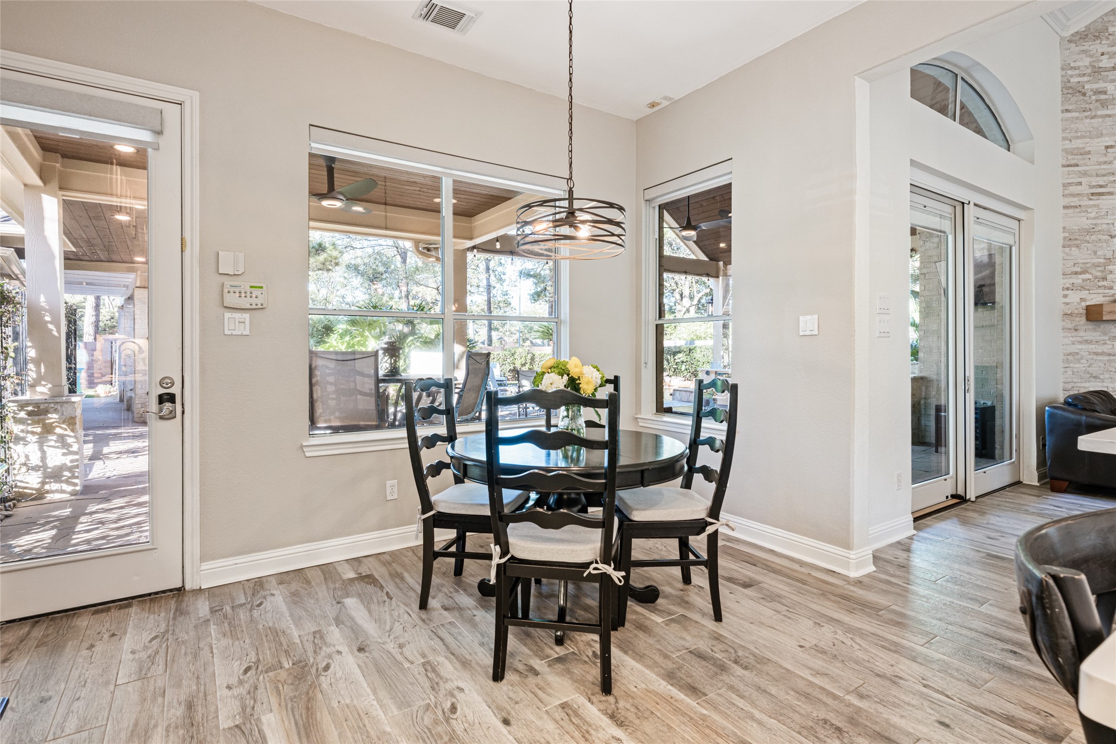 22806 2 Rivers Lane Katy, TX 77450 - Photo 26 of 49 Bright breakfast area with large windows and glass doors, offering a view of the outdoor space. This inviting nook offers a perfect spot for casual dining while enjoying views of the backyard and outdoor living area.