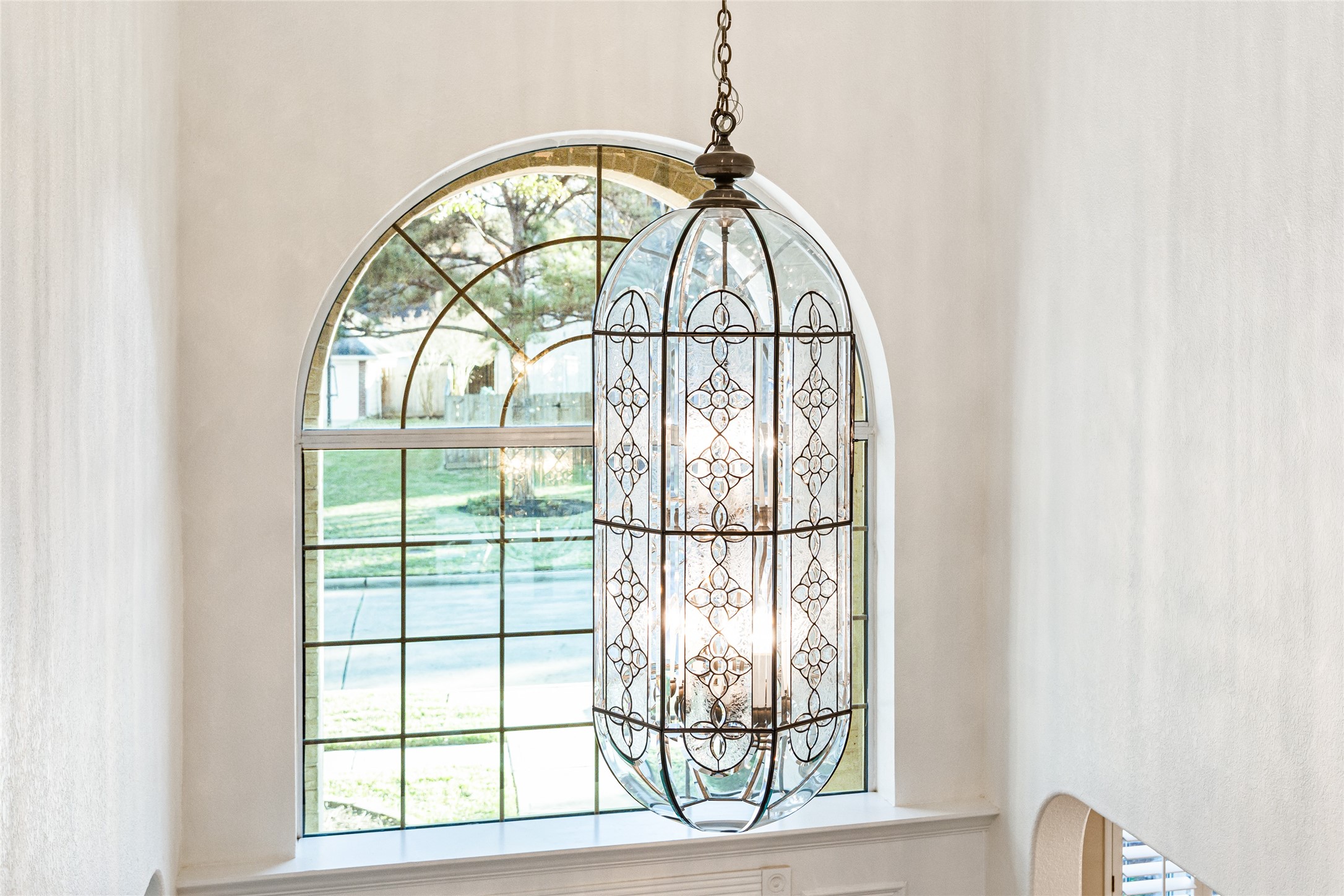 22806 2 Rivers Lane Katy, TX 77450 - Photo 34 of 49 This photo showcases a spacious interior with a large, arched window that lets in plenty of natural light. A decorative, elegant chandelier hangs prominently, adding a touch of sophistication to the space.