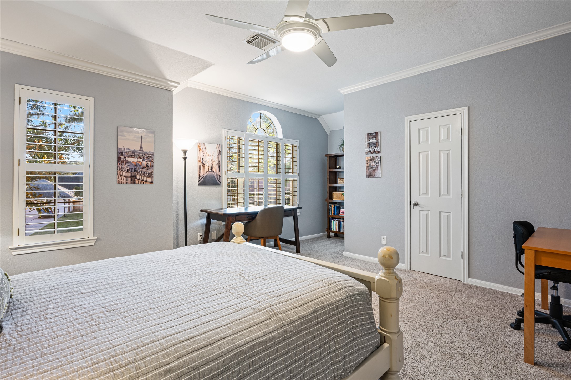 22806 2 Rivers Lane Katy, TX 77450 - Photo 36 of 49 This generous secondary bedroom features crown molding, carpeted flooring, and ample natural light through multiple windows with plantation shutters. It includes a ceiling fan, and a cozy corner. The space is inviting and well-suited for relaxation or productivity. Closet space is quite ample, as well.