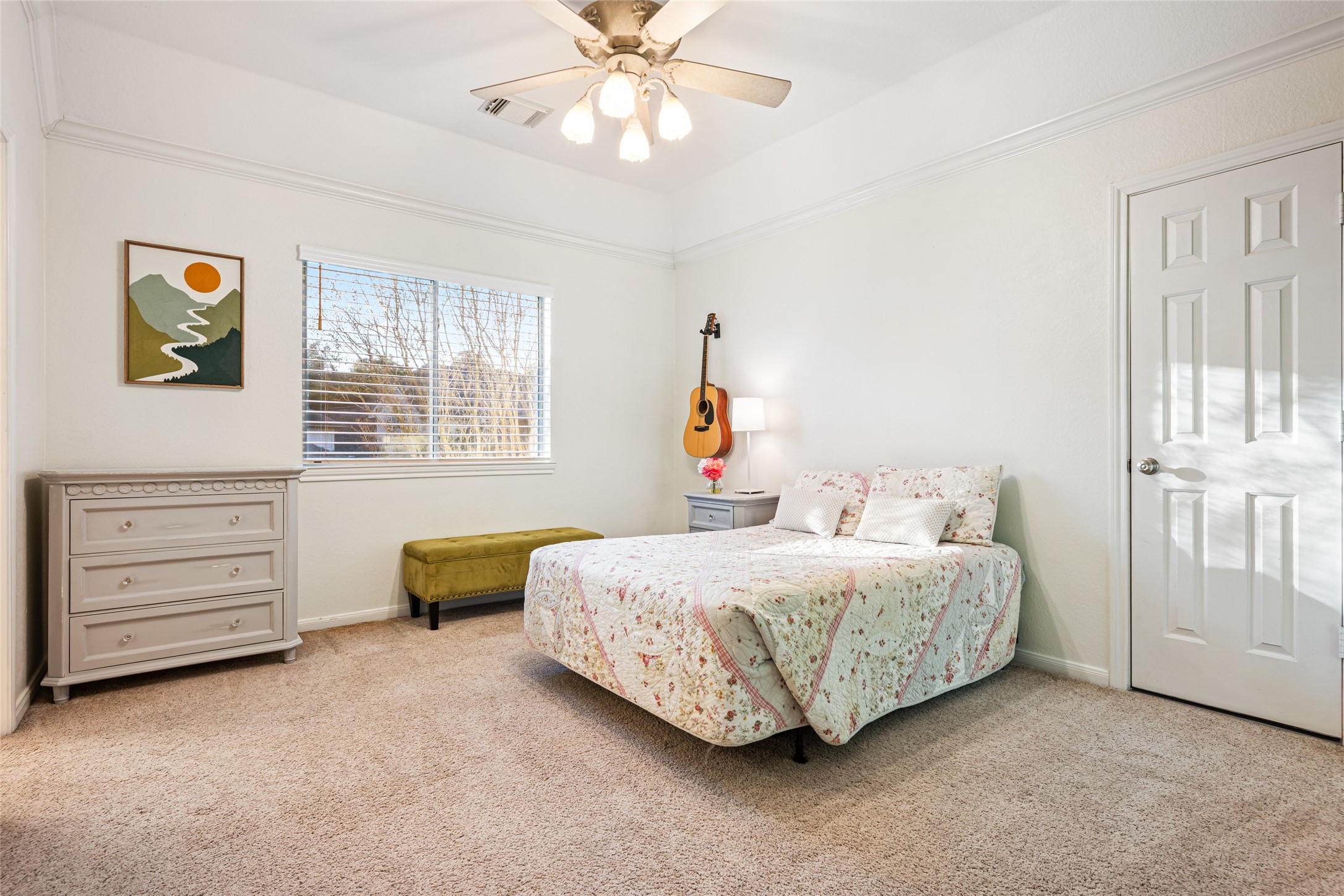 22806 2 Rivers Lane Katy, TX 77450 - Photo 38 of 49 Ample sized secondary bedroom with neutral walls, carpeted floor, and ceiling fan. This room features a shared ensuite bath and generous walk-in closet space, offering comfort and convenience for guests or family members. An additional door provides access to extra attic storage, adding valuable functionality and flexibility.