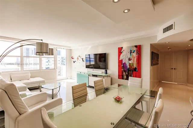 a living room with furniture a flat screen tv and a large window