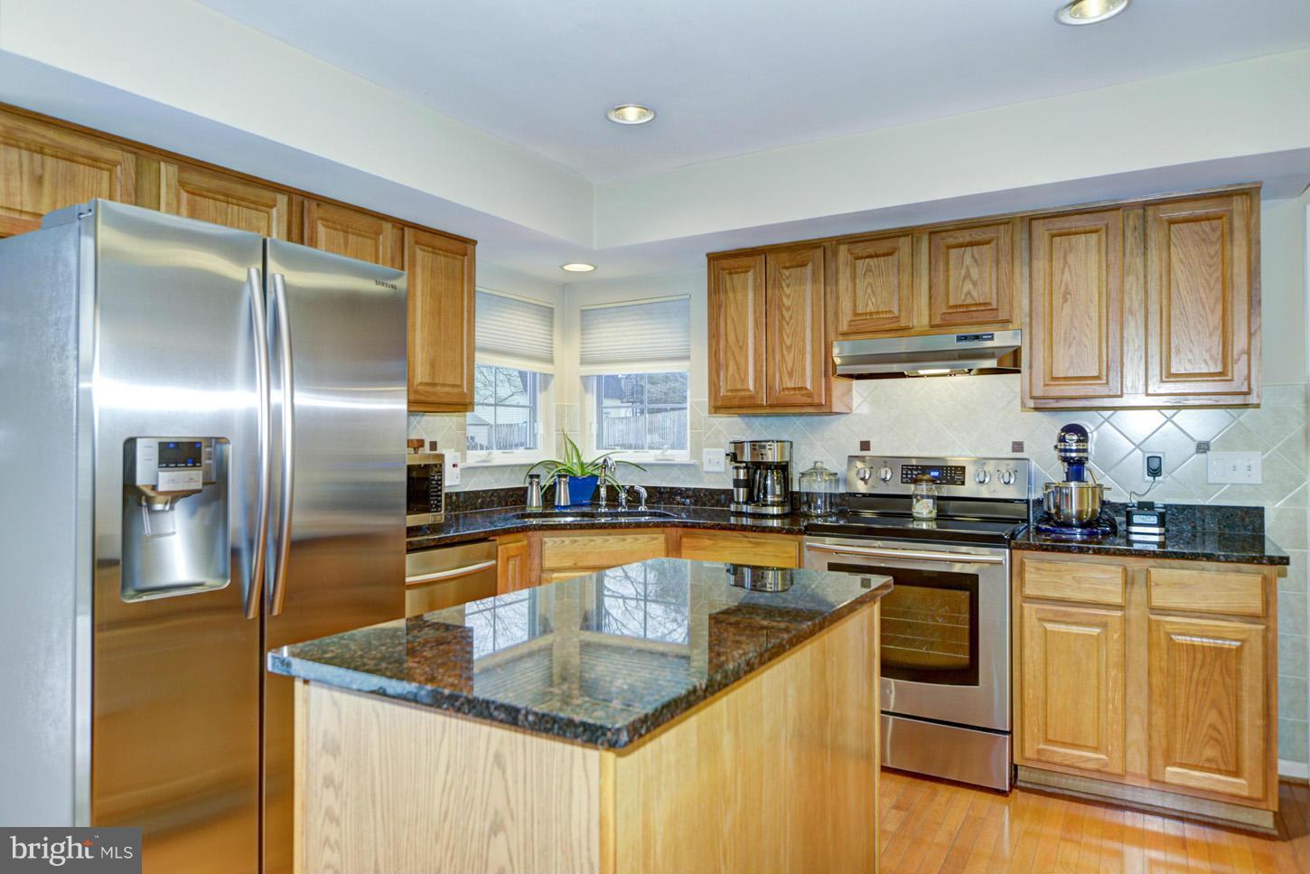 9522 Rommel Drive Columbia, MD 21046 - Photo 2 of 30 a kitchen with stainless steel appliances granite countertop a sink a stove and refrigerator