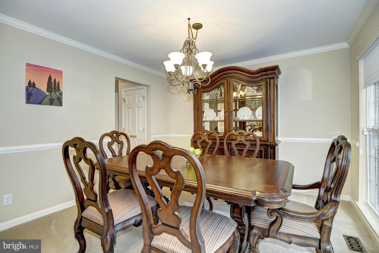 9522 Rommel Drive Columbia, MD 21046 - Photo 12 of 30 a view of a dining room with furniture a chandelier and wooden floor