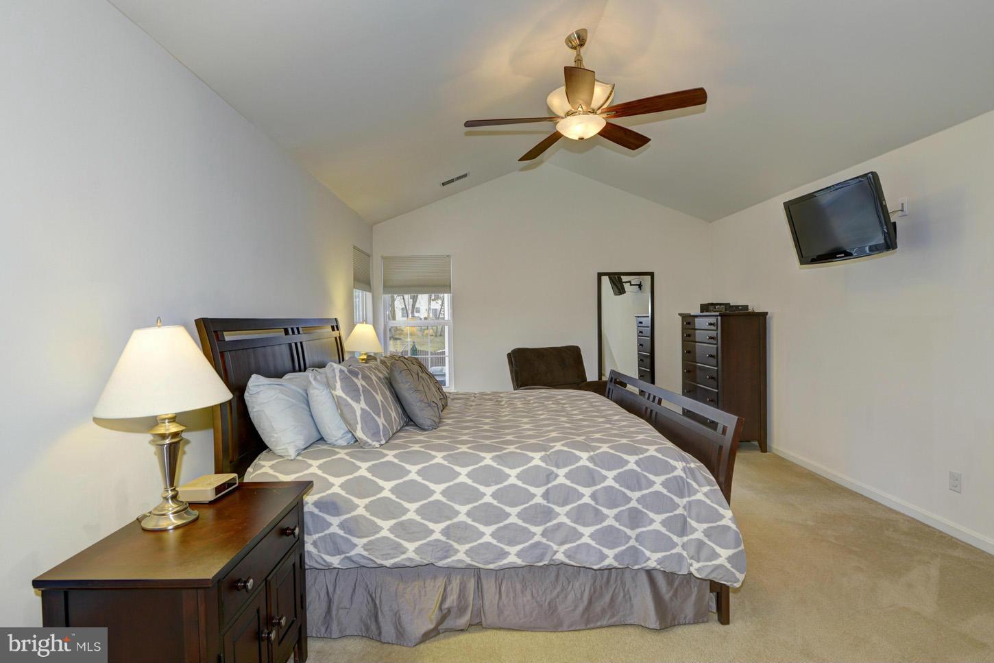 9522 Rommel Drive Columbia, MD 21046 - Photo 18 of 30 a bedroom with a bed and a chandelier