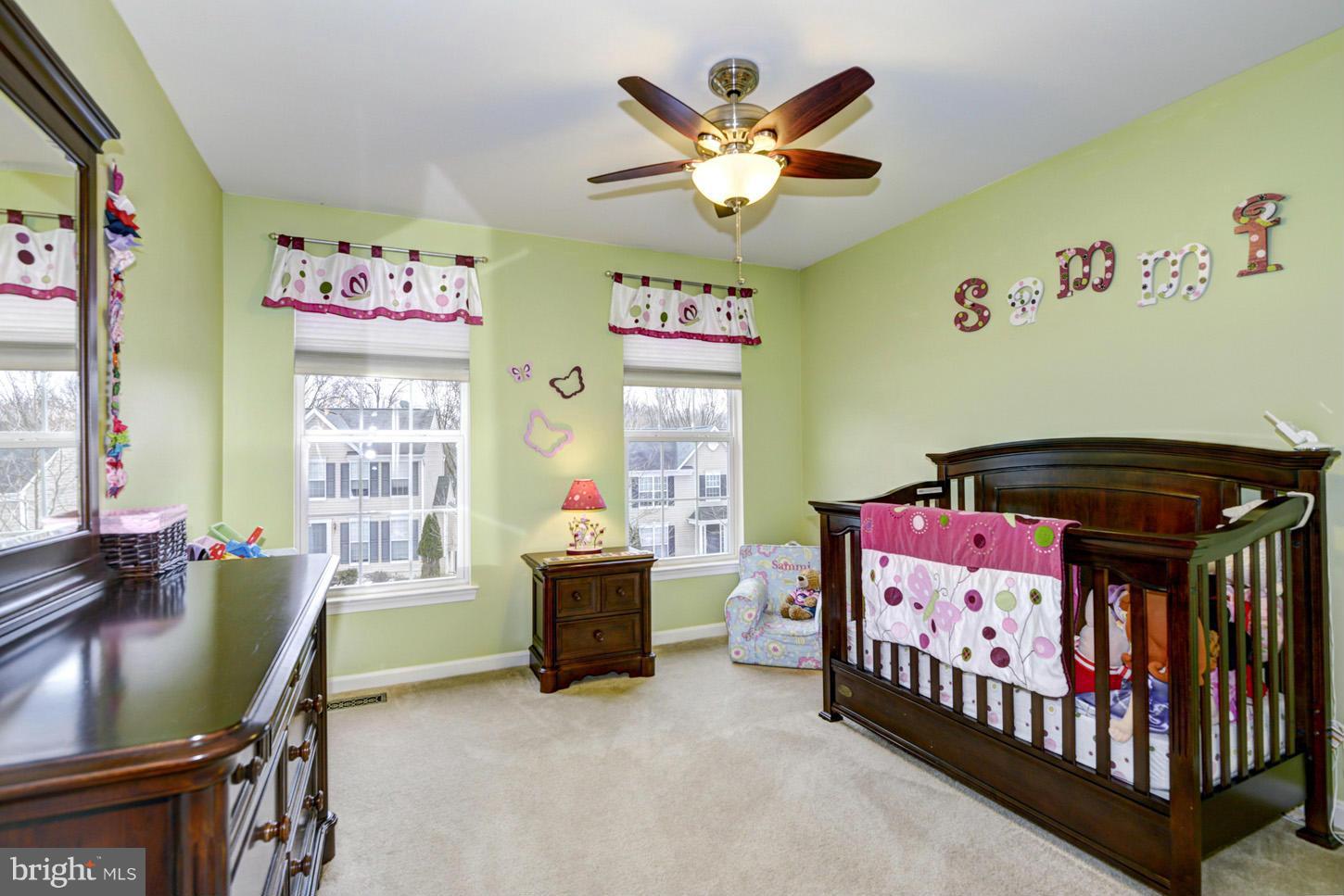 9522 Rommel Drive Columbia, MD 21046 - Photo 20 of 30 a bedroom with a bed and a chandelier