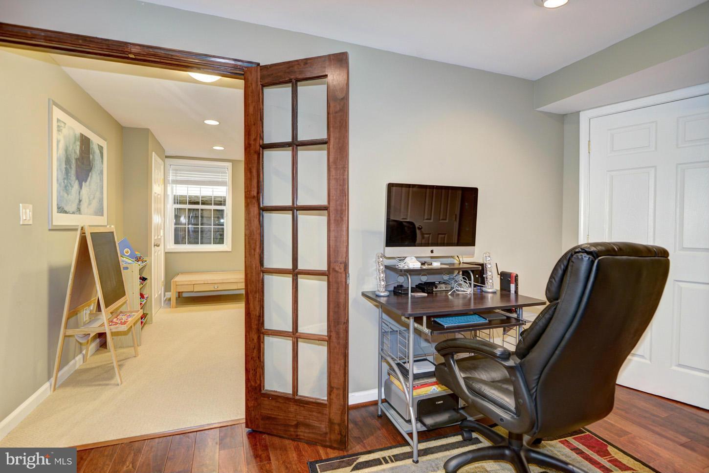 9522 Rommel Drive Columbia, MD 21046 - Photo 25 of 30 a view of a workspace with furniture and a flat screen tv