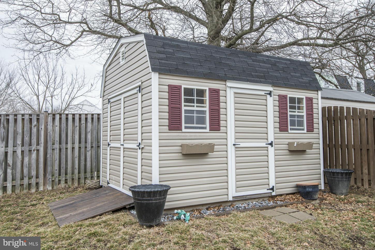 9522 Rommel Drive Columbia, MD 21046 - Photo 30 of 30 a view of house with wooden fence and a large tree