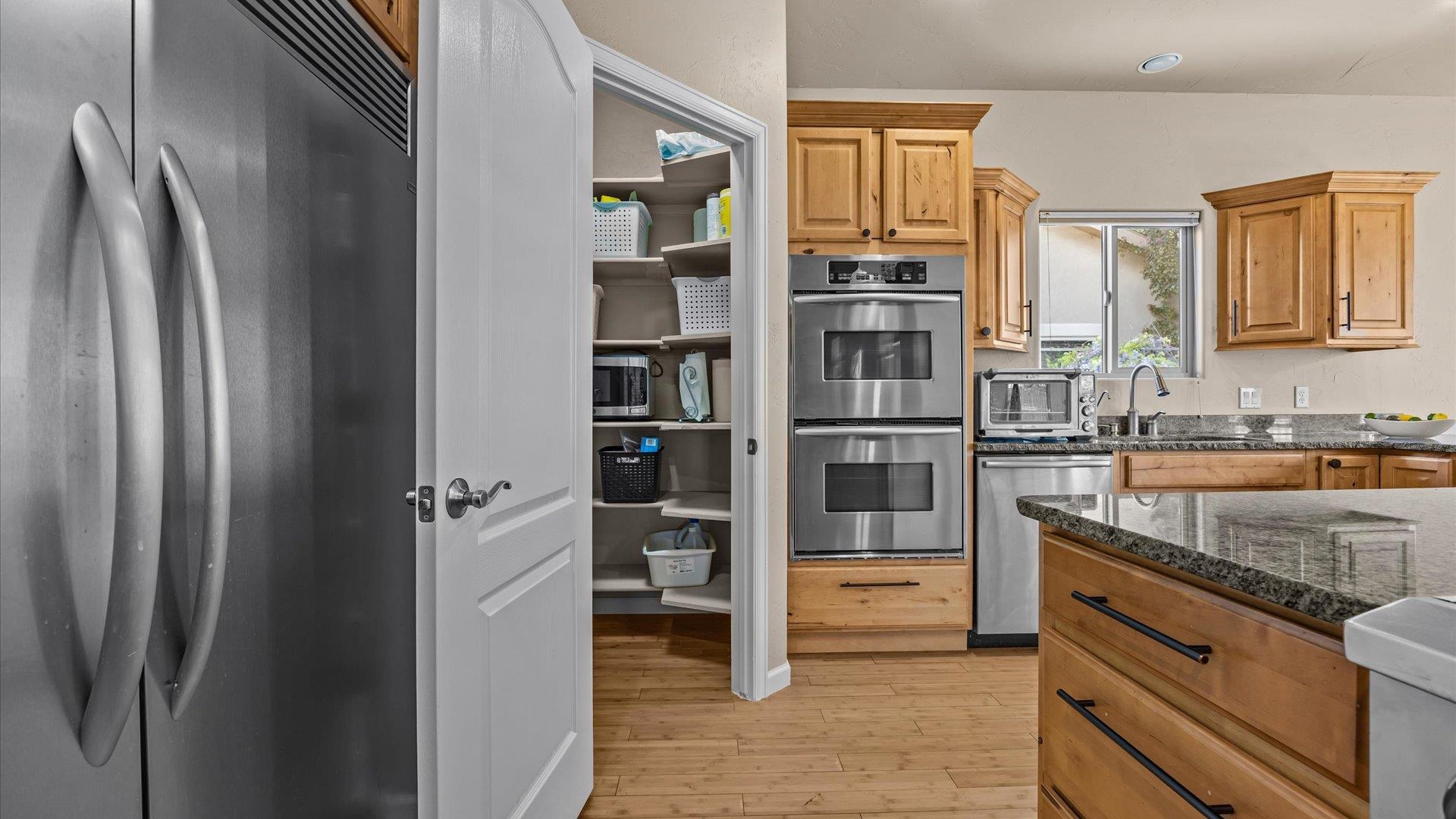 1712 Powis Lane Fruita, CO 81521 - Photo 13 of 39 a kitchen with stainless steel appliances granite countertop a refrigerator and a sink
