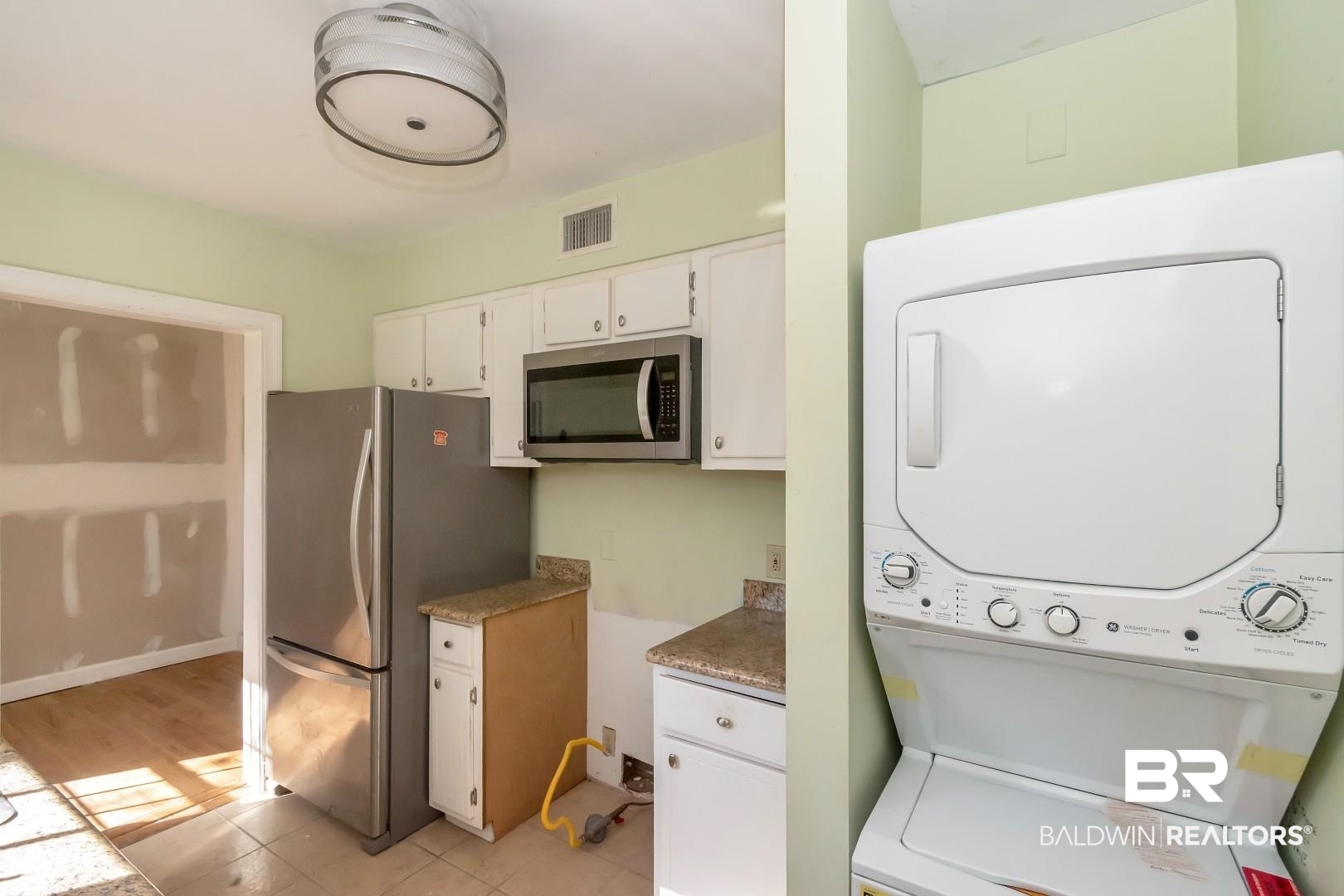 214 Upham Street, Unit 4A Mobile, AL 36607 - Photo 15 of 23 Clothes washing area featuring laundry area, stacked washer / dryer, and visible vents