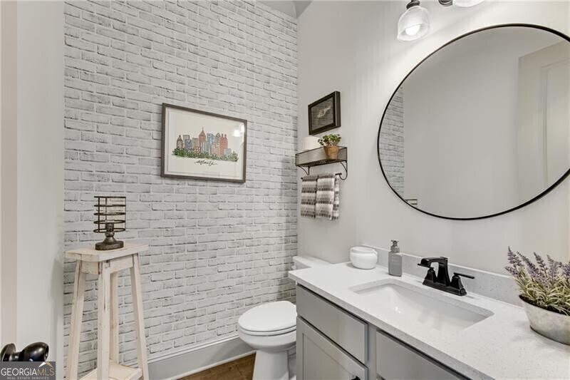 485 Delaperriere Loop Jefferson, GA 30549 - Photo 11 of 69 a bathroom with a toilet sink vanity and mirror