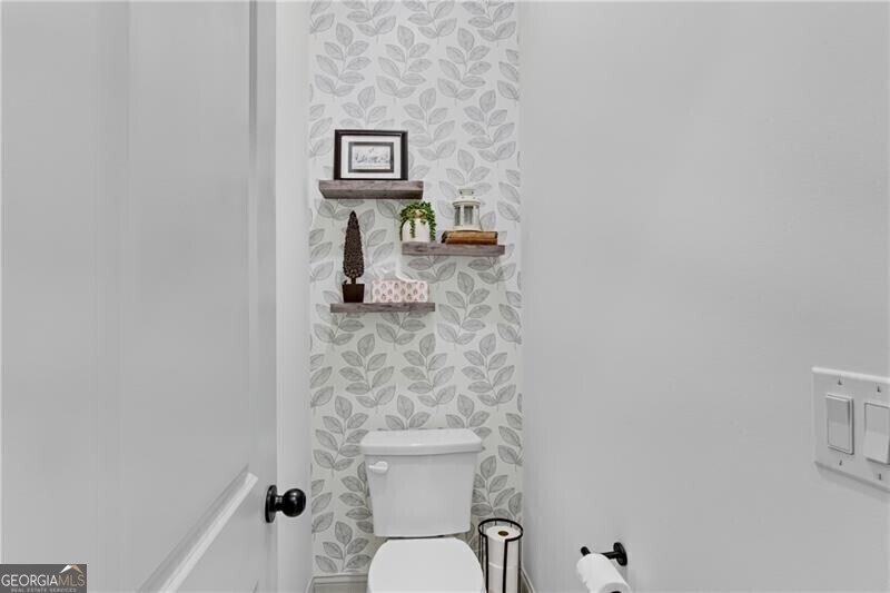 485 Delaperriere Loop Jefferson, GA 30549 - Photo 31 of 69 a bathroom with a toilet and a shower curtain