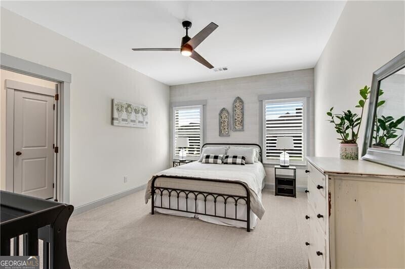 485 Delaperriere Loop Jefferson, GA 30549 - Photo 37 of 69 a bedroom with a bed a chandelier and a dresser