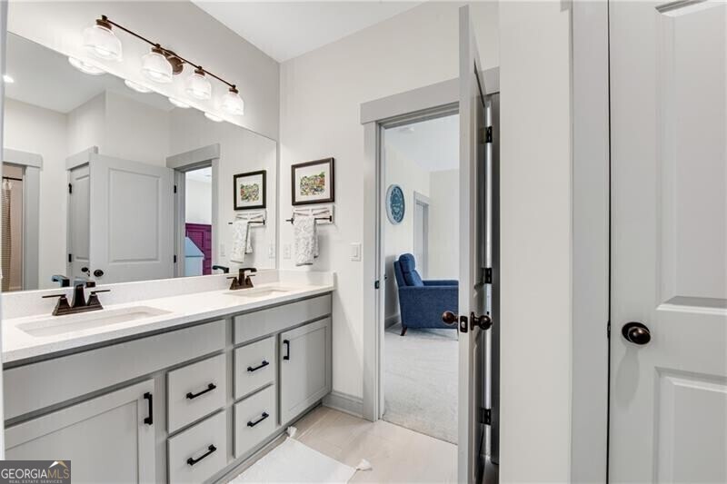 485 Delaperriere Loop Jefferson, GA 30549 - Photo 39 of 69 a en suite bathroom with a double vanity sink a mirror and shower