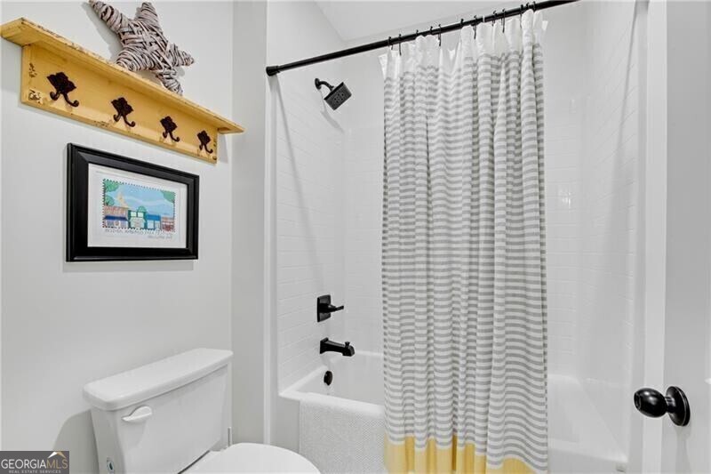 485 Delaperriere Loop Jefferson, GA 30549 - Photo 41 of 69 a bathroom with a toilet and a shower curtain