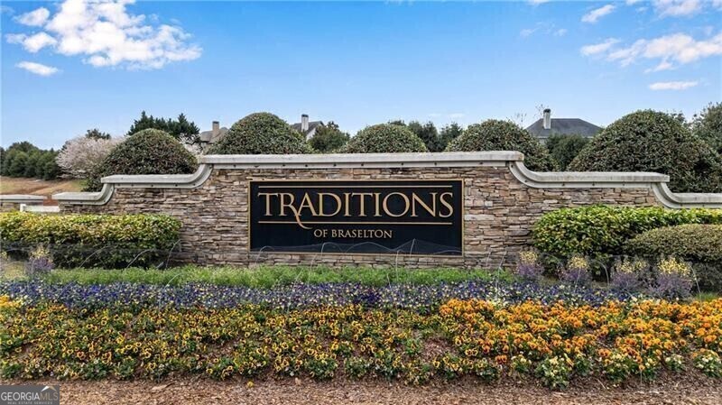 485 Delaperriere Loop Jefferson, GA 30549 - Photo 59 of 69 a view of a sign board with flower plants in front of house