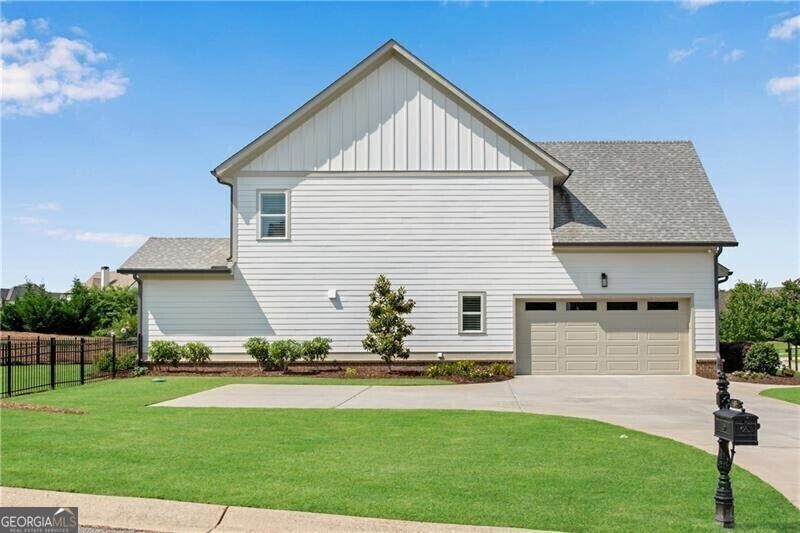 485 Delaperriere Loop Jefferson, GA 30549 - Photo 9 of 69 a front view of house with yard and trees in the background