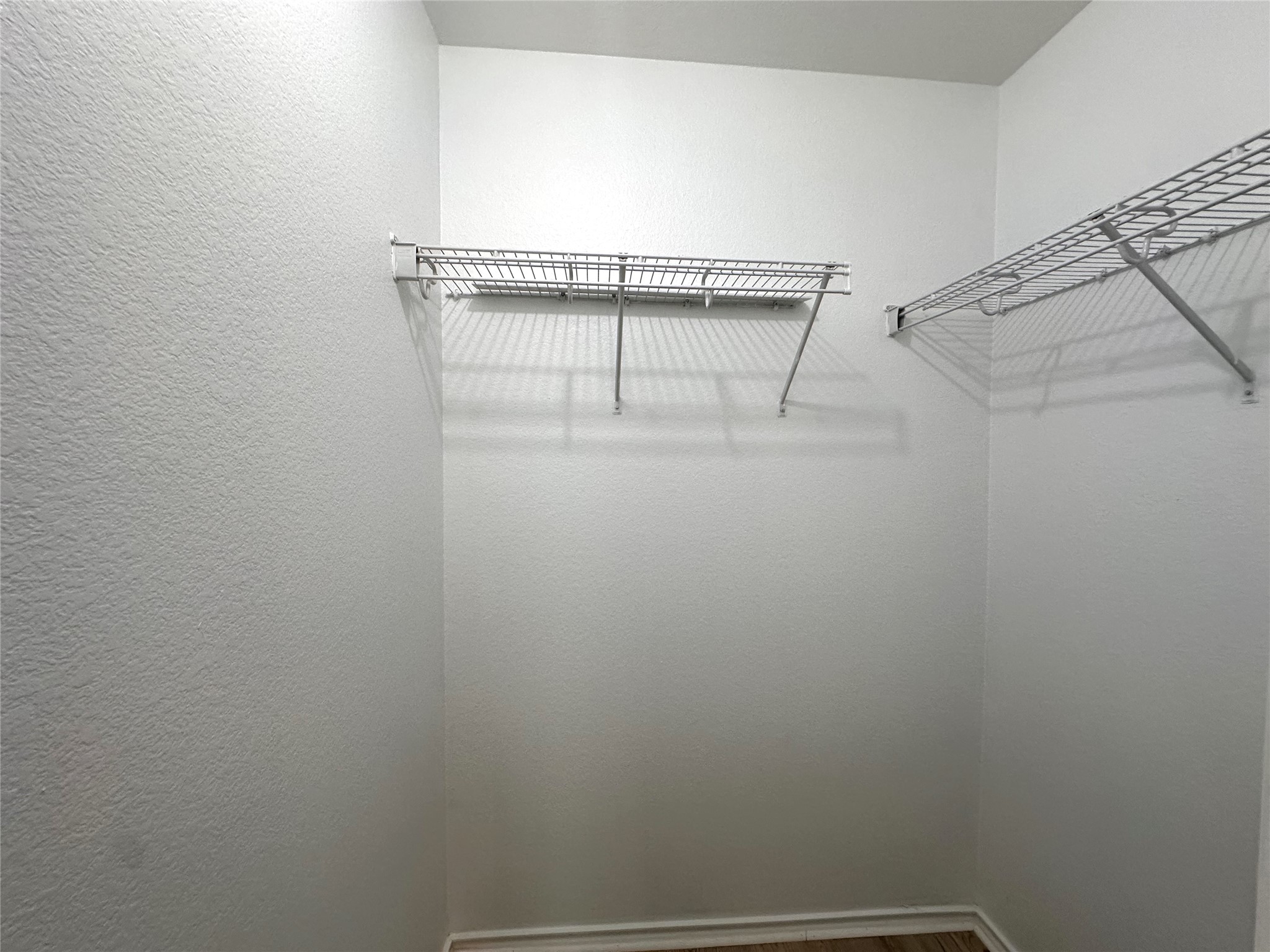 722 Lavaca Loop Elgin, TX 78621 - Photo 17 of 24 Walk in closet featuring dark wood-style flooring