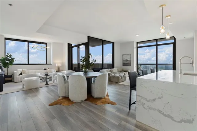 a living room with couches a coffee table and a large window with outer view
