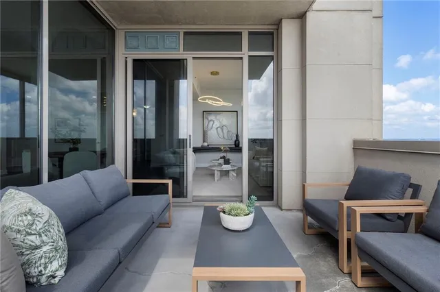 a kitchen with stainless steel appliances a table chairs refrigerator and microwave