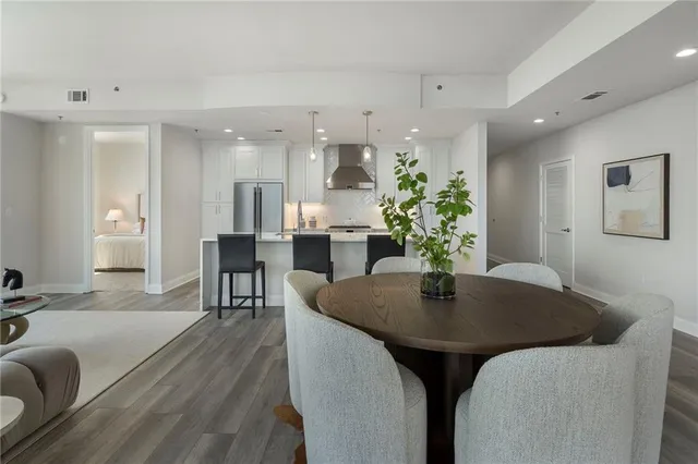 a kitchen with stainless steel appliances a stove a table a sink and a refrigerator