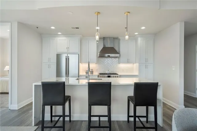 a kitchen with stainless steel appliances granite countertop a sink and a stove top oven