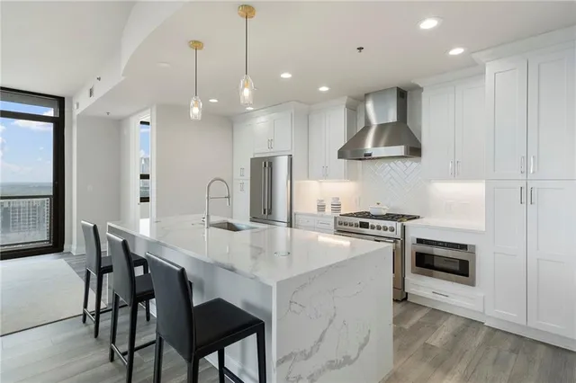 a view of living room with furniture and large windows