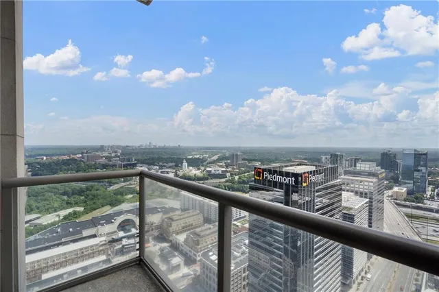 a bedroom with bed and a large window
