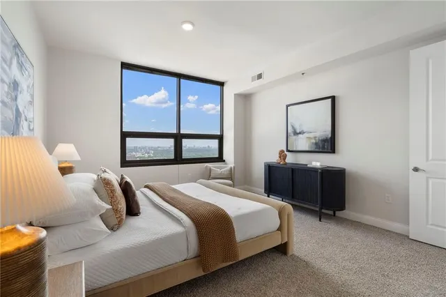 a bedroom with a bed and window