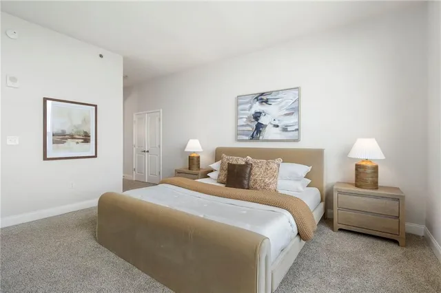 a bedroom with a bed and a lamp