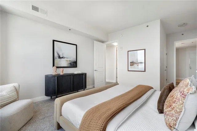 a bedroom with a bed and a large window