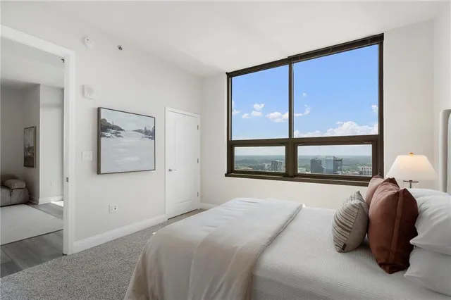 a living room with furniture flat screen tv and wooden floor