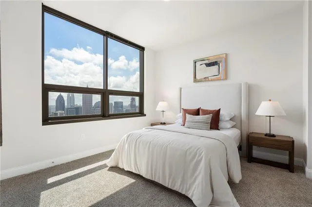 a living room with furniture a flat screen tv and a table
