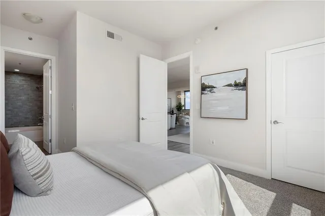 a living room with furniture fireplace and a large window