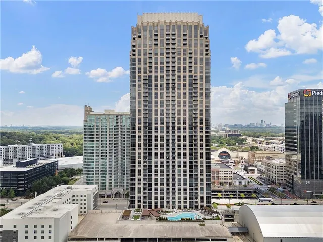 a dining room with furniture a chandelier and wooden floor