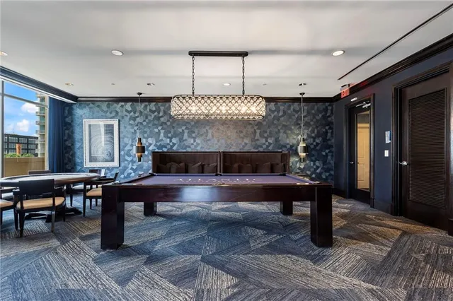 a lobby with furniture and a large mirror