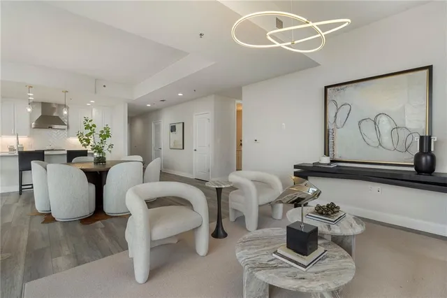 a living room with furniture and a floor to ceiling window