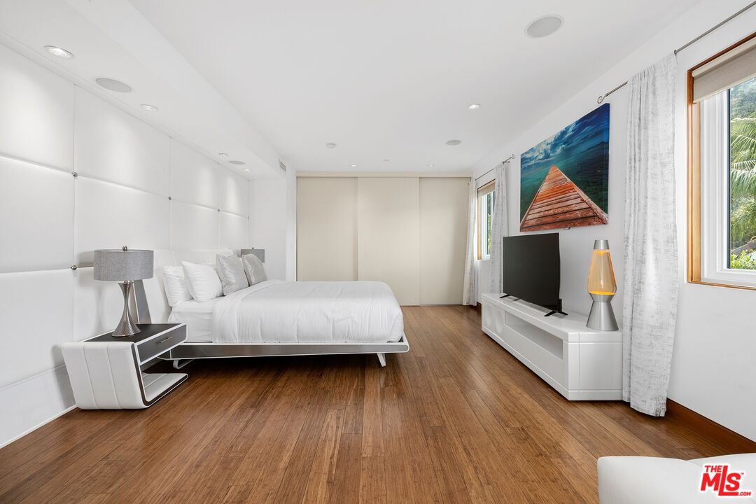 2437 Apollo Drive Los Angeles, CA 90046 - Photo 12 of 27 a bedroom with a bed and wooden floor