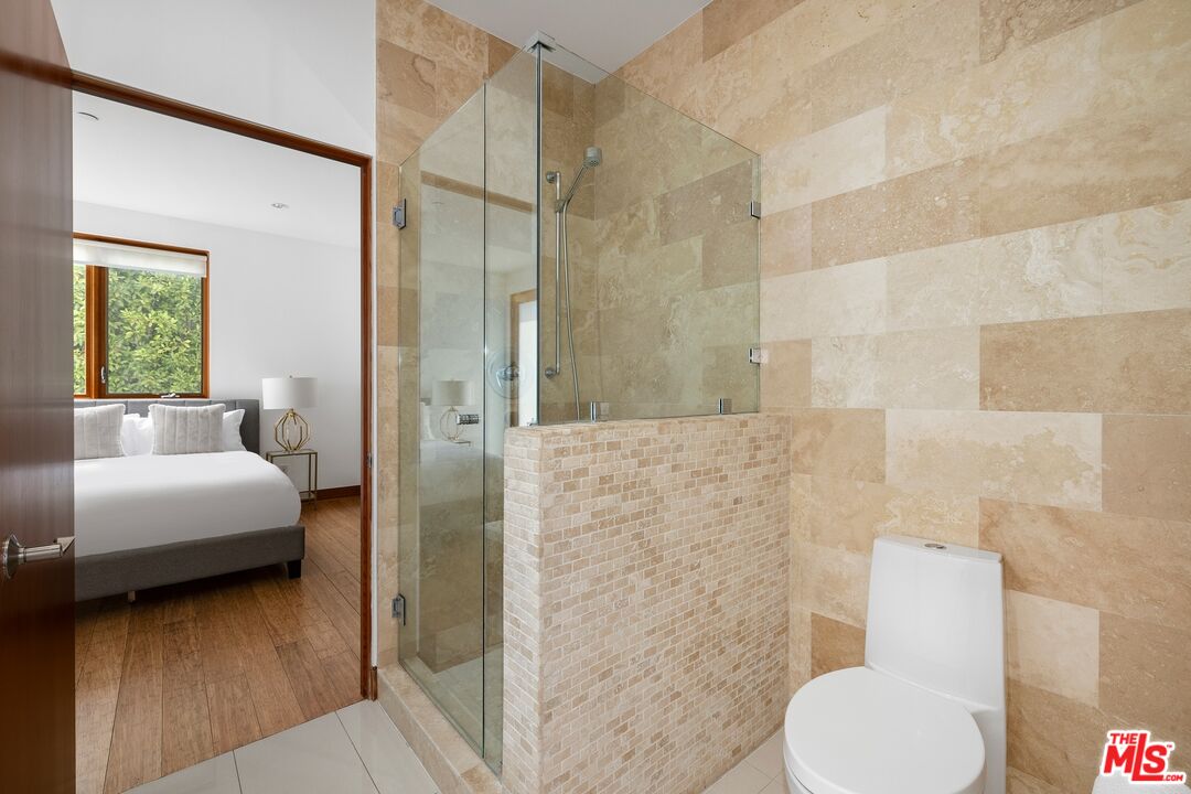 2437 Apollo Drive Los Angeles, CA 90046 - Photo 13 of 27 a bathroom with a toilet tub and a shower