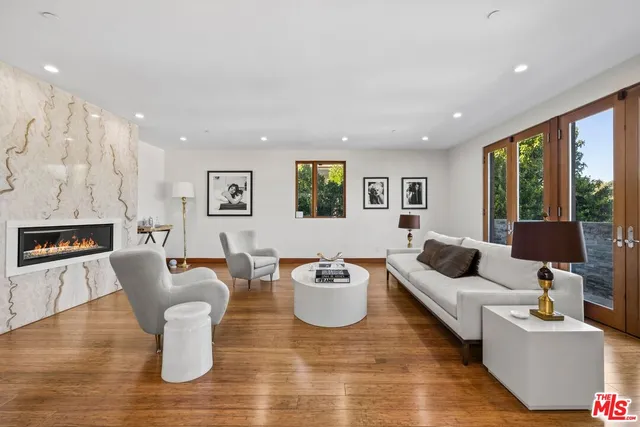 a living room with fireplace furniture and a wooden floor