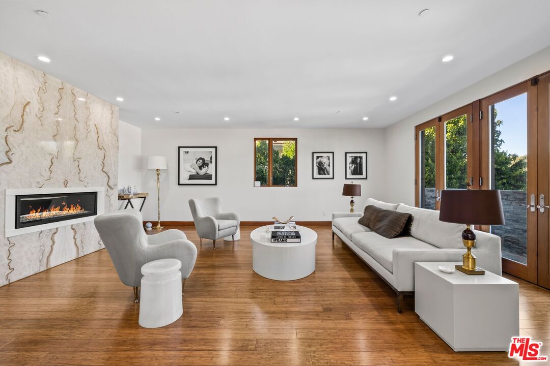 2437 Apollo Drive Los Angeles, CA 90046 - Photo 2 of 27 a living room with fireplace furniture and a wooden floor