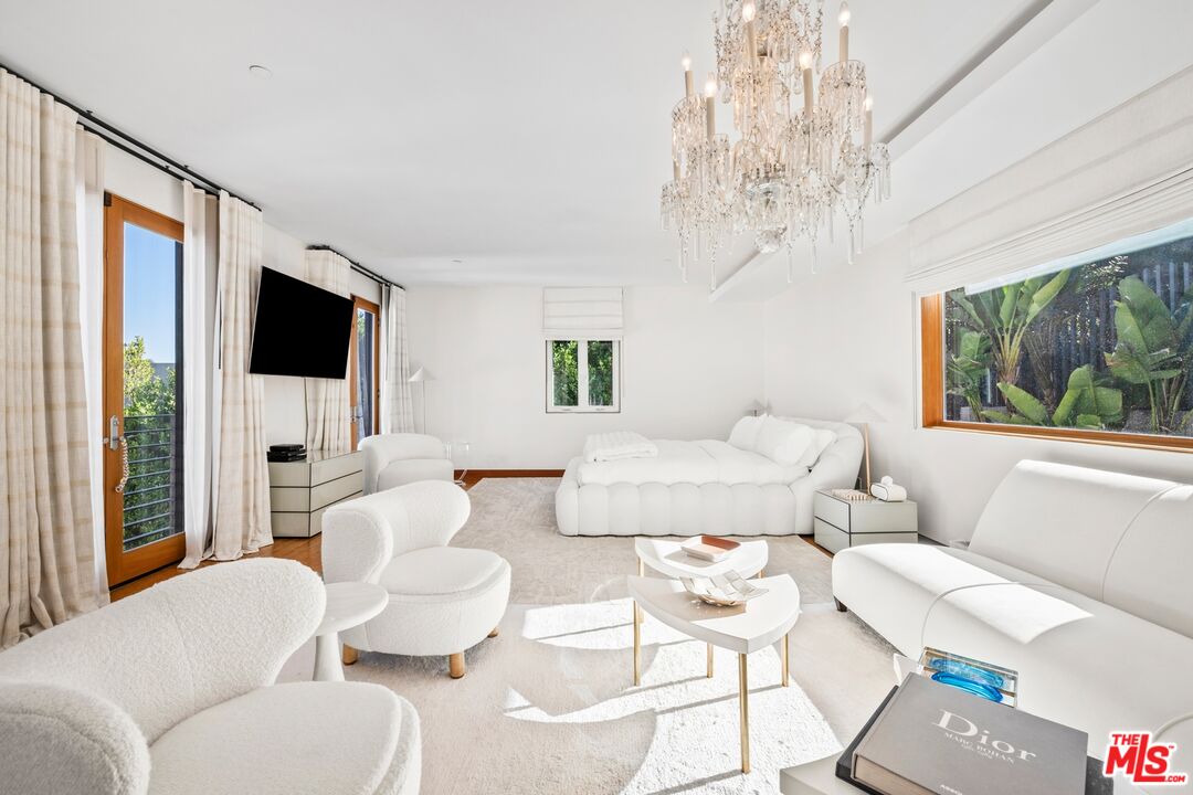 2437 Apollo Drive Los Angeles, CA 90046 - Photo 4 of 27 a living room with furniture a flat screen tv and a large window