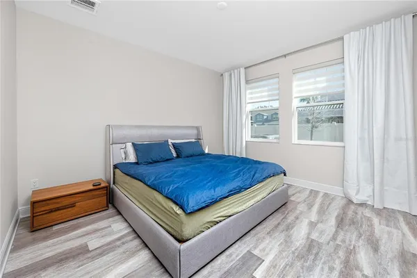 a bed sitting in a bedroom next to a window