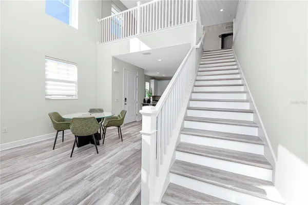a view of a dining room with furniture and wooden floor