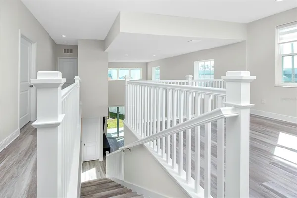 a view of staircase with white walls and a window