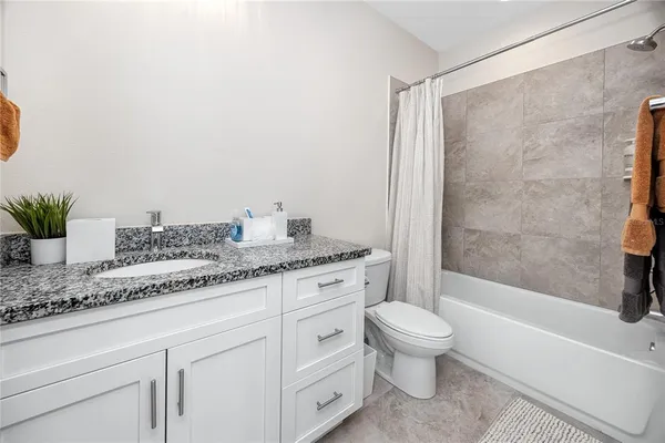 a bathroom with a bathtub and shower