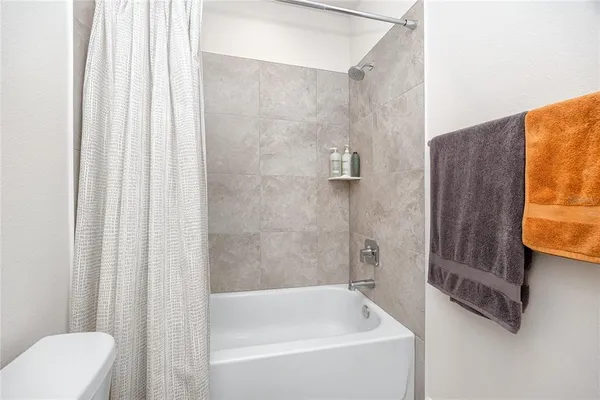 a spacious bedroom with a bed and window