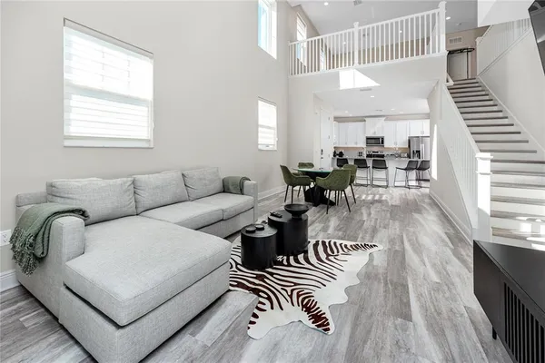a living room with furniture and wooden floor