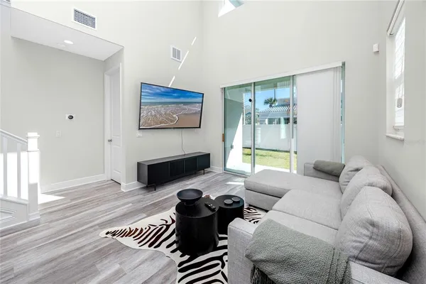 a living room with furniture a lamp and a table