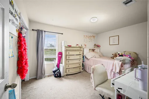 a bedroom with bed and a chandelier